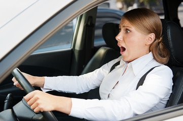 frightened woman holding the steering wheel