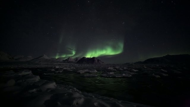 Aurora Borealis over the frozen Arctic fiord