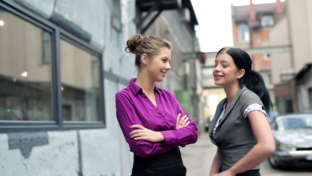 Portrait of two smiling businesswomen on coffee break, outdoors