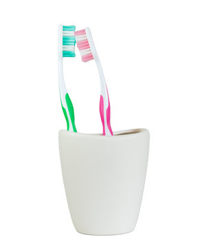 green and pink tooth brush face to fcae closeup