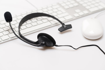 Office black headphones on white keyboard