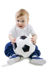 Baby sitting on floor with football ball