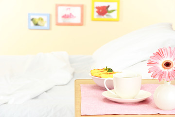 light breakfast on the nightstand next to the bed