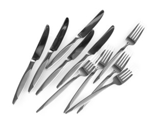 a set of knives and forks isolated on white