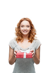 young red-haired happy smiling girl holding gift