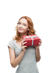 Fototapeta premium young red-haired happy smiling girl holding gift