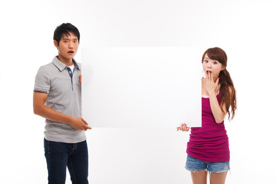 Young couple take white panel isolated on white background.