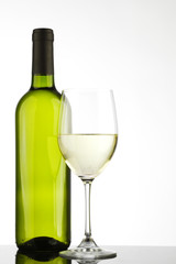 bottle with white wine and glass