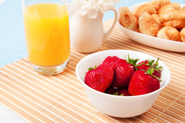 Breakfast with berries,orange juice and croissant