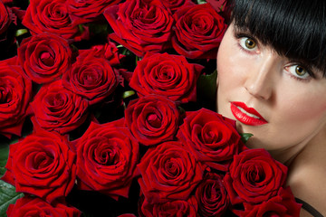 brunette woman with red roses - obrazy, fototapety, plakaty