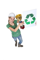 A female construction worker first in recycling.
