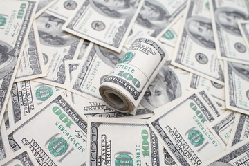 roll of dollars on 100 dollar bills background