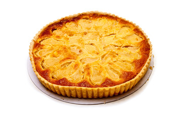 Pear and frangipane tart on a white stuido background.