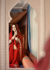Beautiful Indian bride looking in mirror