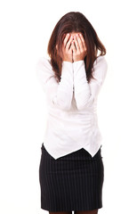 Young woman has shut face with hands, isolated on white backgrou