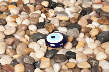 Blue Evil Eye Blue on the pebbles background