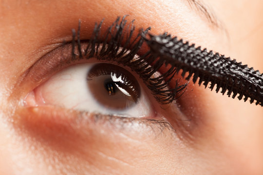 Woman applying mascara