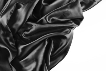 Black textured silk fabric on white. Copy space