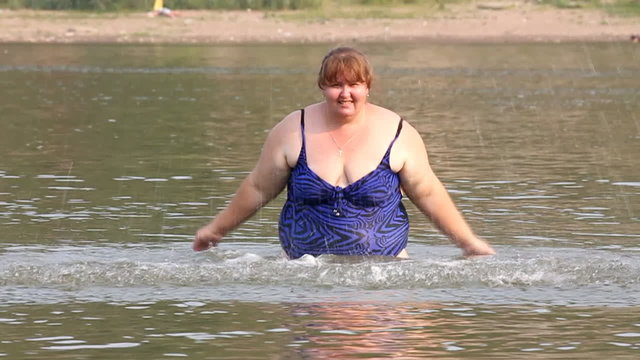 woman with overweight bath in river