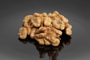 Delicious walnuts on a black ceramic plate