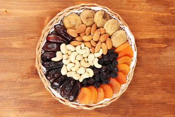 different dried fruits on wooden background
