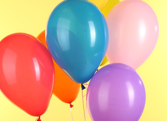 colorful balloons on yellow background