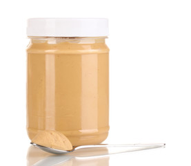 Delicious peanut butter in jar isolated on white