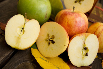 Apples on wood and leaves