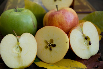 Apples on wood and leaves