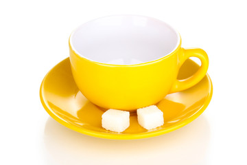 Yellow cup and saucer isolated on white