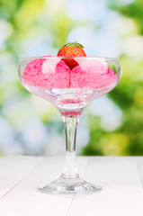 delicious ice cream on wooden table on bright background