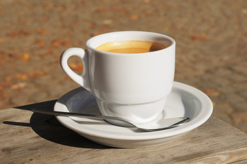 Hot coffee in white ceramic cup on village table