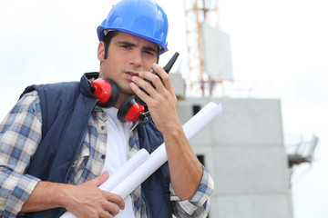 Tradesman speaking into a walkie talkie