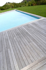 Closeup of private pool and wood deck