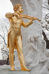 Johann Strauss statue near trees