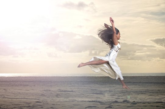 Beautiful African Girl Jumping in White Dress