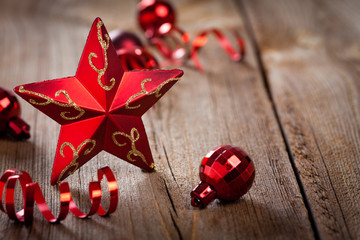 red star , gifts and ribbons on weathered wooden board