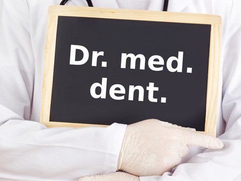 Doctor shows information on blackboard: dr med dent