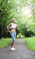 Girl with fit abdominal with bottle of water