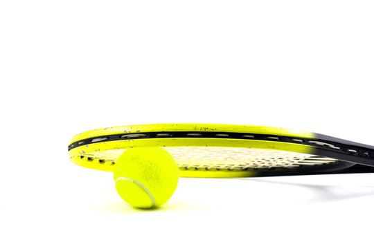 Tennis balls and racquet on white background