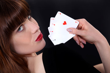 Alluring woman playing cards