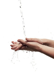 Female hands among splashing water - isolated