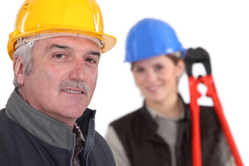 Manual worker and young female assistant