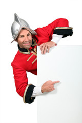 Palace guard pointing at advertising board