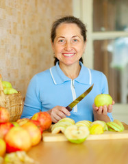 Woman cuts apples for apple jam