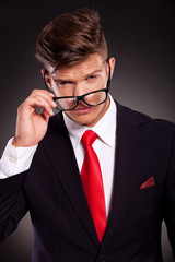 business man taking off eyeglasses