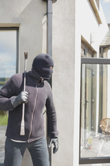 Robber hiding behind a wall