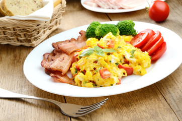 Omelette with vegetables and fried bacon