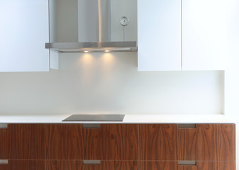 Actual modern kitchen in white and walnut wood