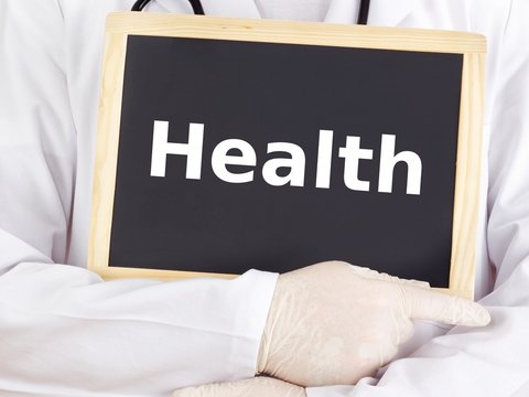 Doctor shows information on blackboard: health